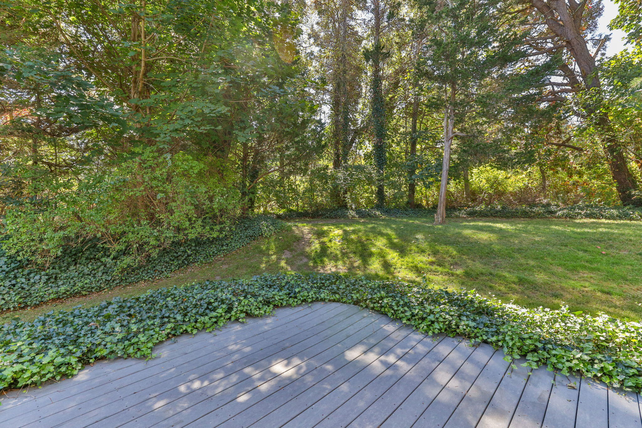 25 Twin Rocks Drive Eastham, MA 02642 - Photo 54 of 61 a view of a yard with wooden fence