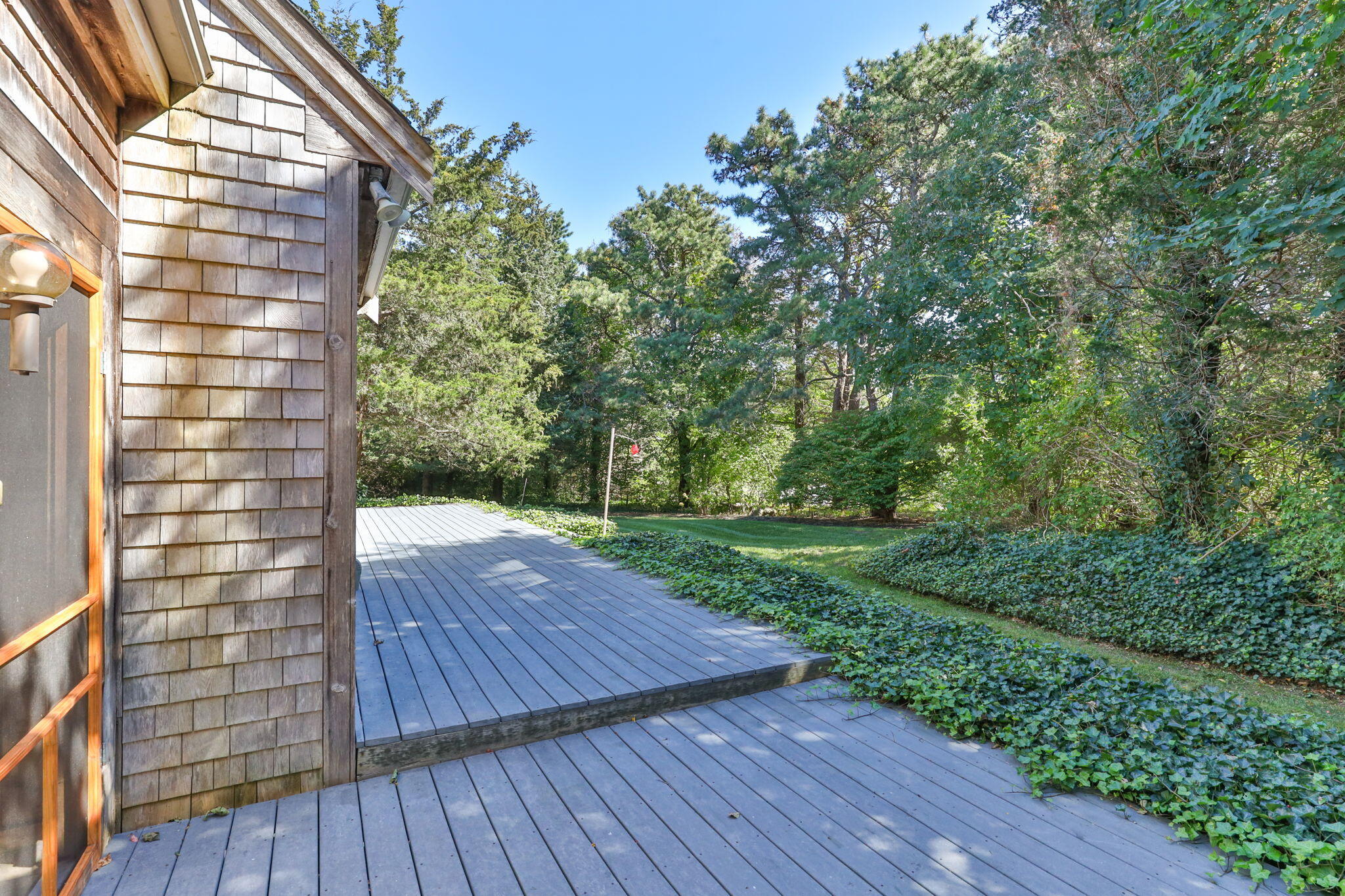 25 Twin Rocks Drive Eastham, MA 02642 - Photo 55 of 61 a view of a backyard with wooden floor and fence