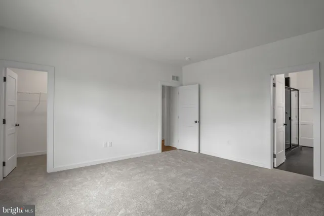 a view of an empty room and closet area