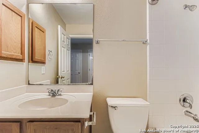 a bathroom with a sink a toilet and a mirror