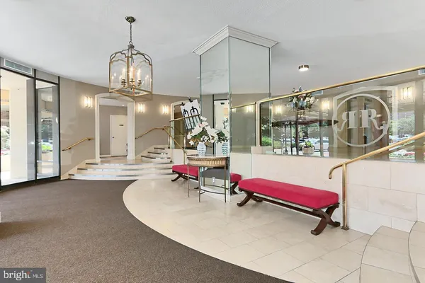 a lobby with chandelier and living room