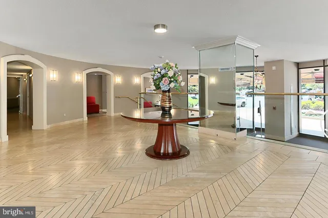 a view of a hallway with wooden floor