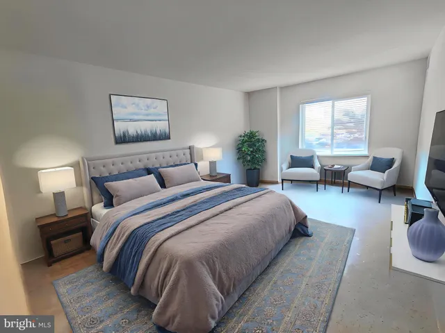 a bedroom with bed and a couch