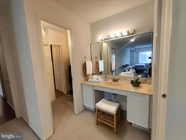 a bathroom with a sink a light fixture and a mirror