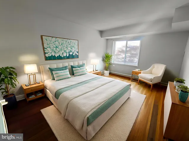 a bedroom with bed and wooden floor