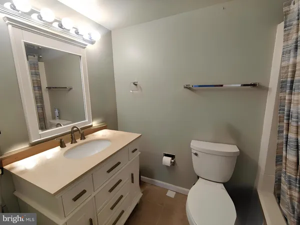 a bathroom with a sink toilet and mirror
