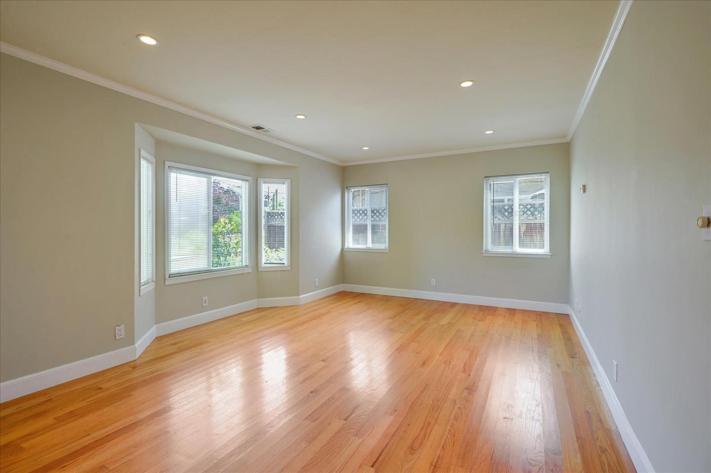 1357 Park Drive, Unit C Mountain View, CA 94040 - Photo 4 of 17 an empty room with wooden floor and windows