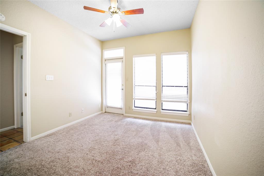 1910 Robbins Place, Unit 208 Austin, TX 78705 - Photo 4 of 9 an empty room with windows and ceiling fan