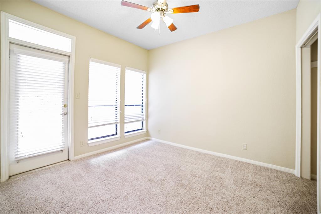 1910 Robbins Place, Unit 208 Austin, TX 78705 - Photo 5 of 9 an empty room with windows and ceiling fan