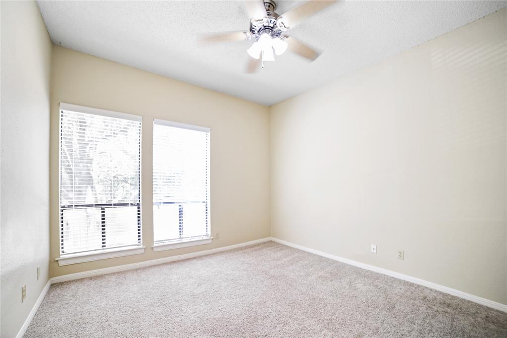 1910 Robbins Place, Unit 208 Austin, TX 78705 - Photo 6 of 9 an empty room with windows and chandelier fan