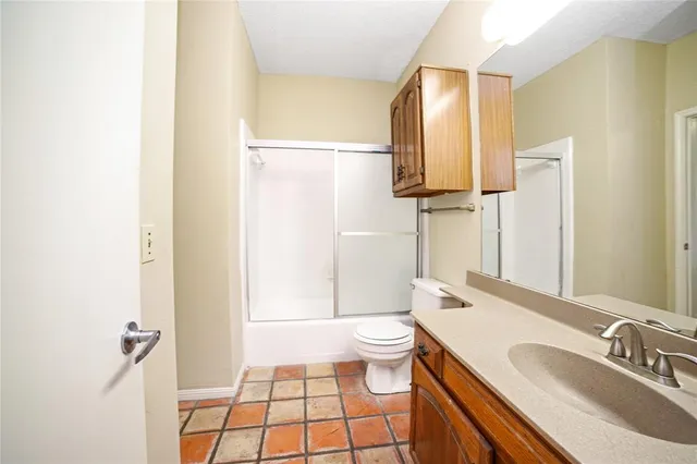 a bathroom with a sink toilet a mirror and shower