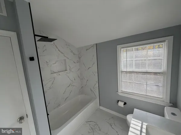 a bathroom with a bathtub and shower