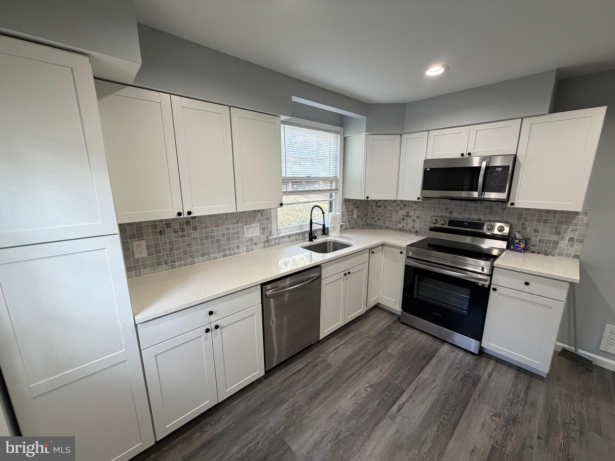 687 Bristol Road Southampton, PA 18966 - Photo 3 of 22 a kitchen with granite countertop white cabinets and white appliances