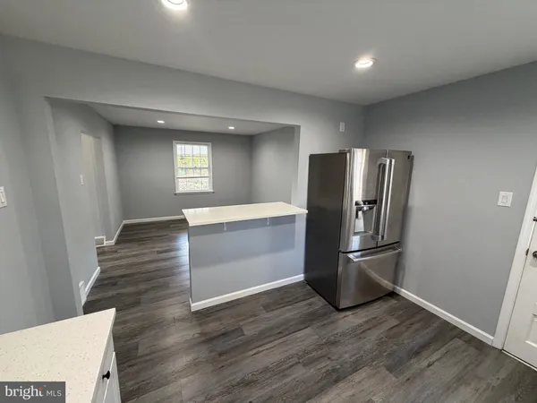 a view of kitchen with furniture and wooden floor