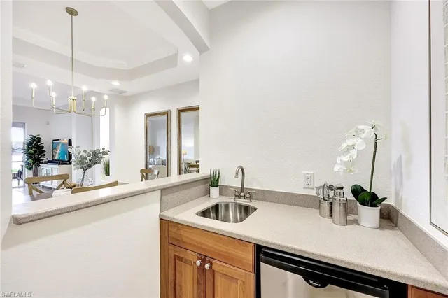 a kitchen with a sink a counter and cabinets
