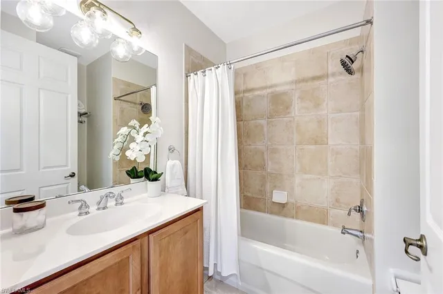 a bathroom with a bathtub sink and mirror