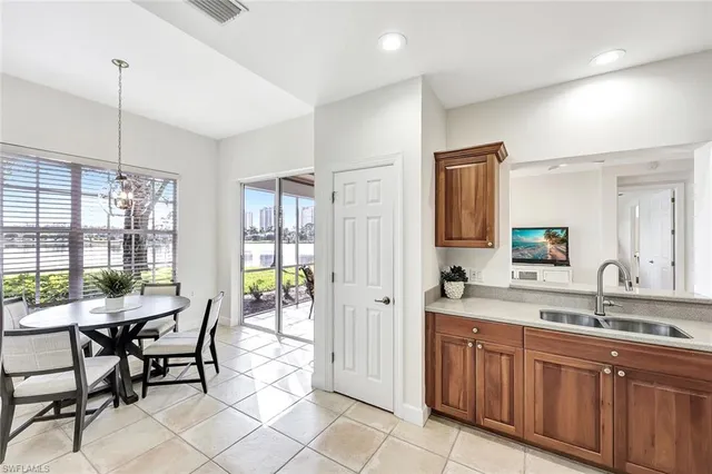 a kitchen with a sink and chairs