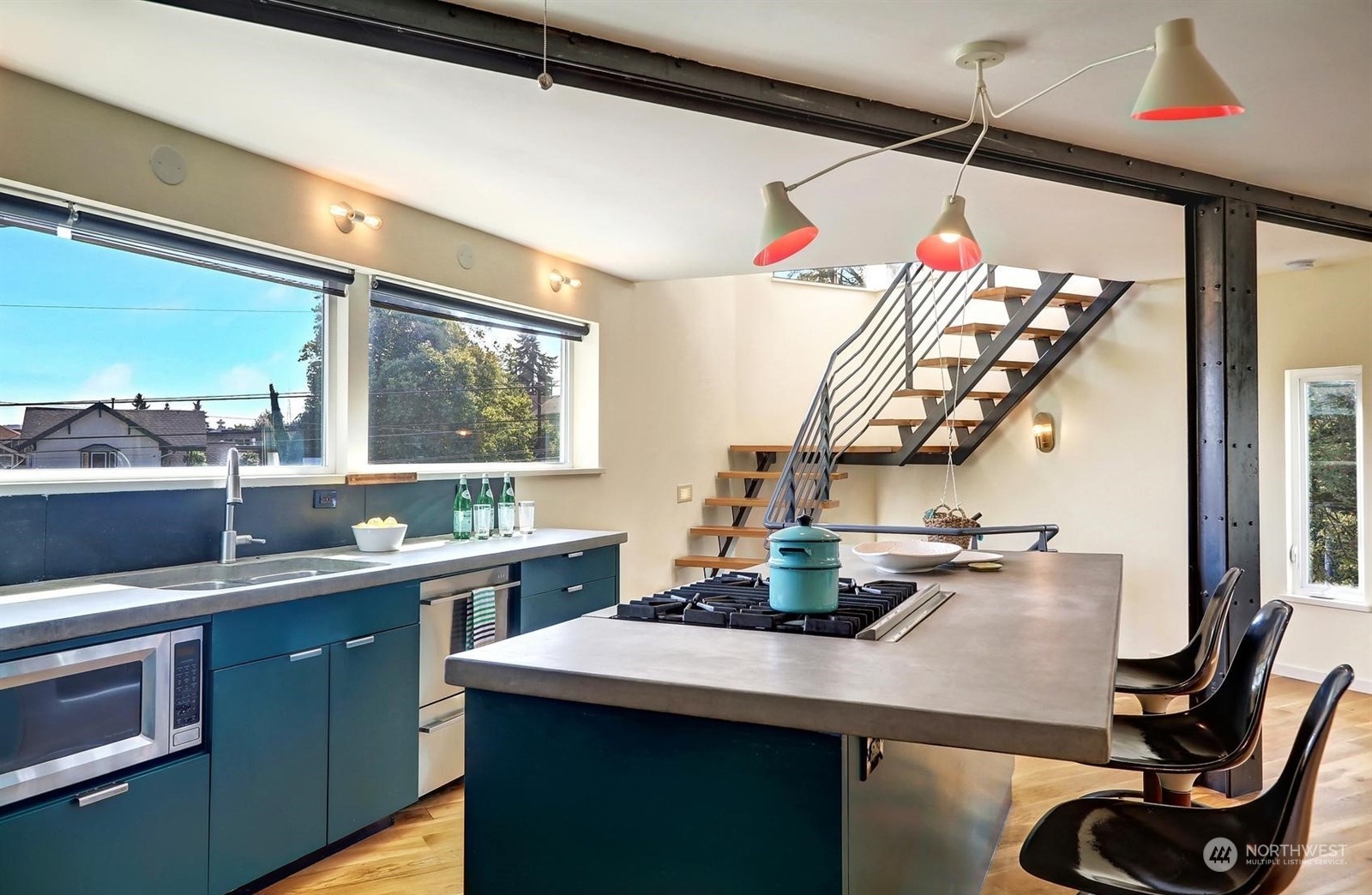 4606 Whitman Avenue North Seattle, WA 98103 - Photo 11 of 40 a kitchen with a sink a stove and a wooden floor