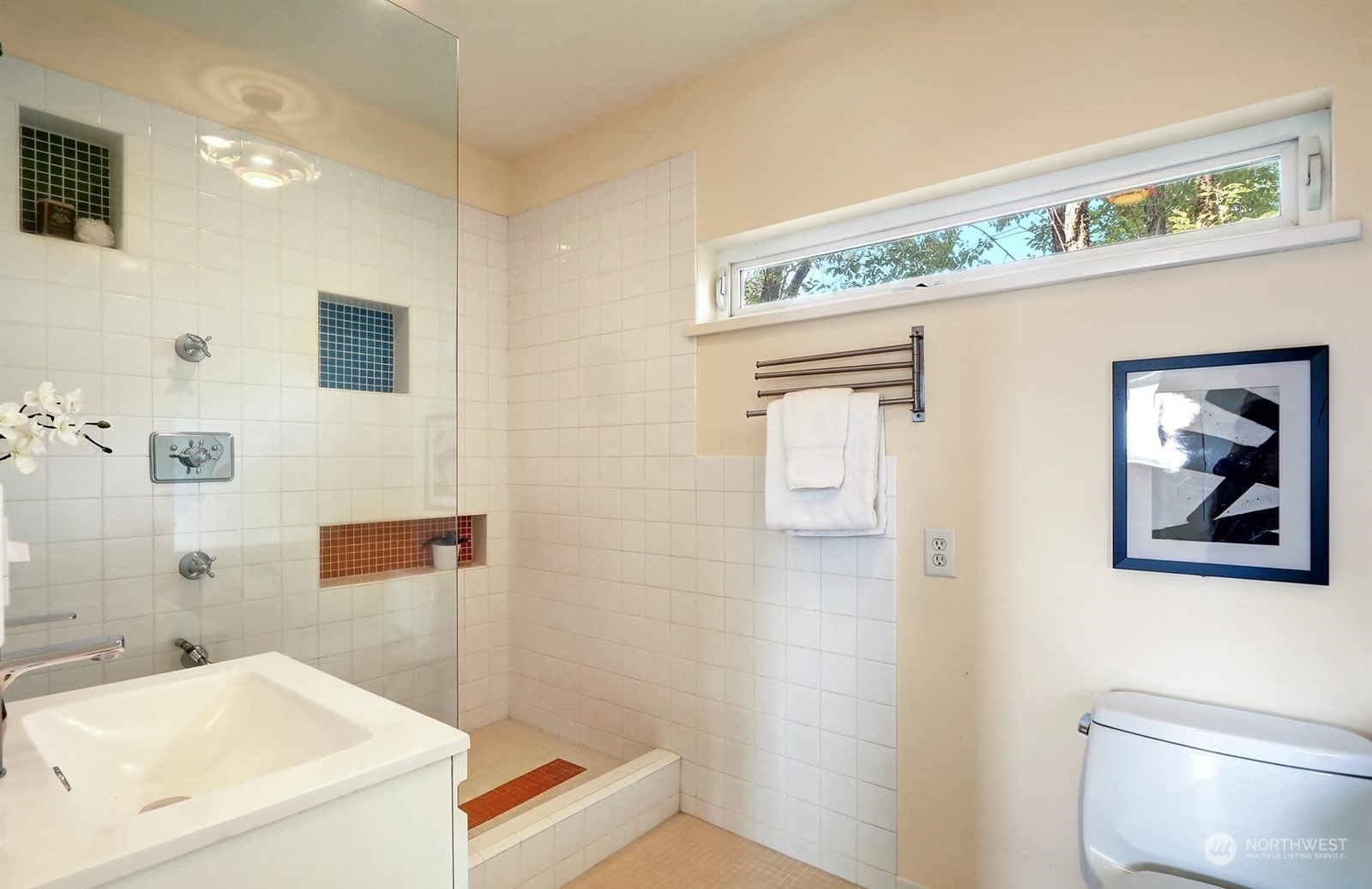 4606 Whitman Avenue North Seattle, WA 98103 - Photo 17 of 40 a bathroom with a sink a toilet and shower