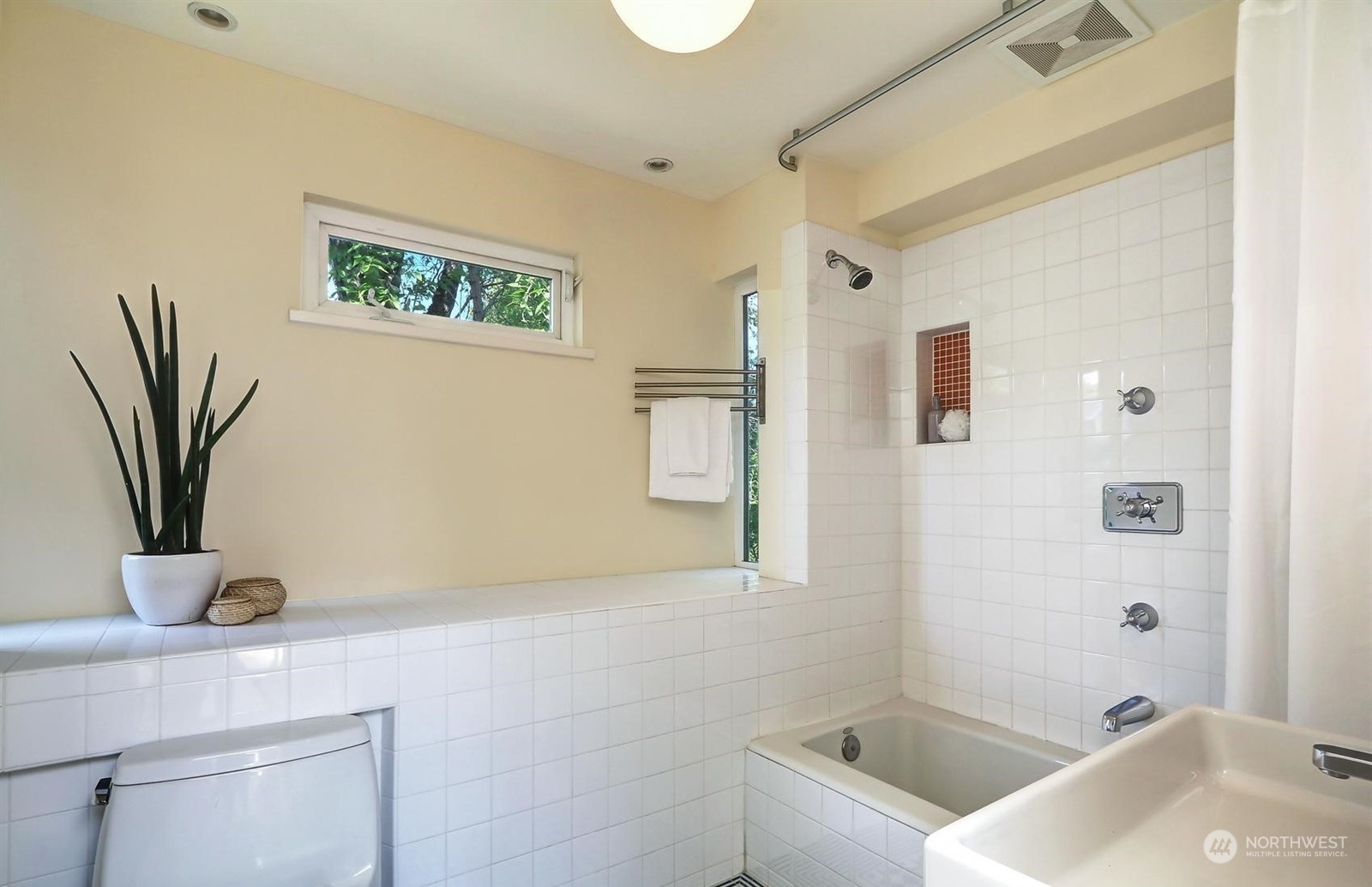 4606 Whitman Avenue North Seattle, WA 98103 - Photo 21 of 40 a bathroom with a tub a sink and mirror