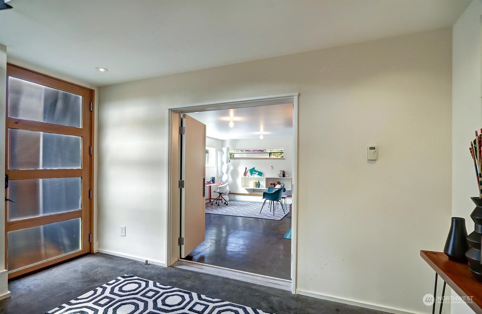 4606 Whitman Avenue North Seattle, WA 98103 - Photo 24 of 40 a view of a hallway with wooden floor and a living room