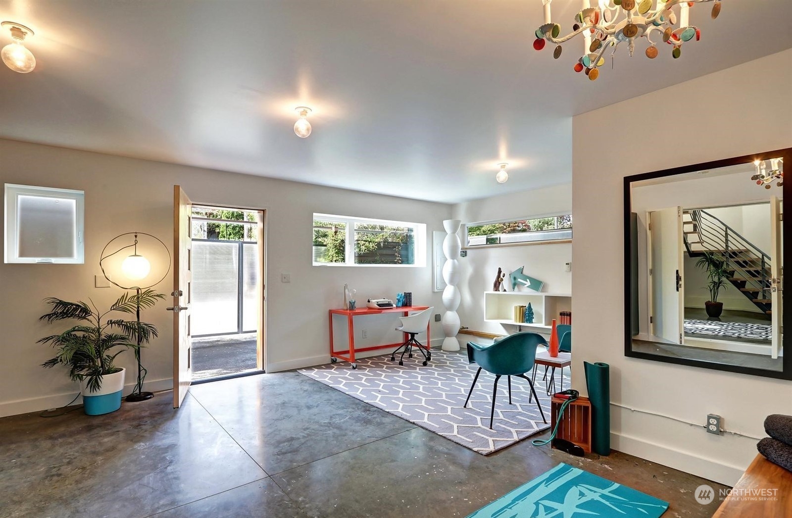 4606 Whitman Avenue North Seattle, WA 98103 - Photo 26 of 40 a living room with furniture a wooden floor and a chandelier