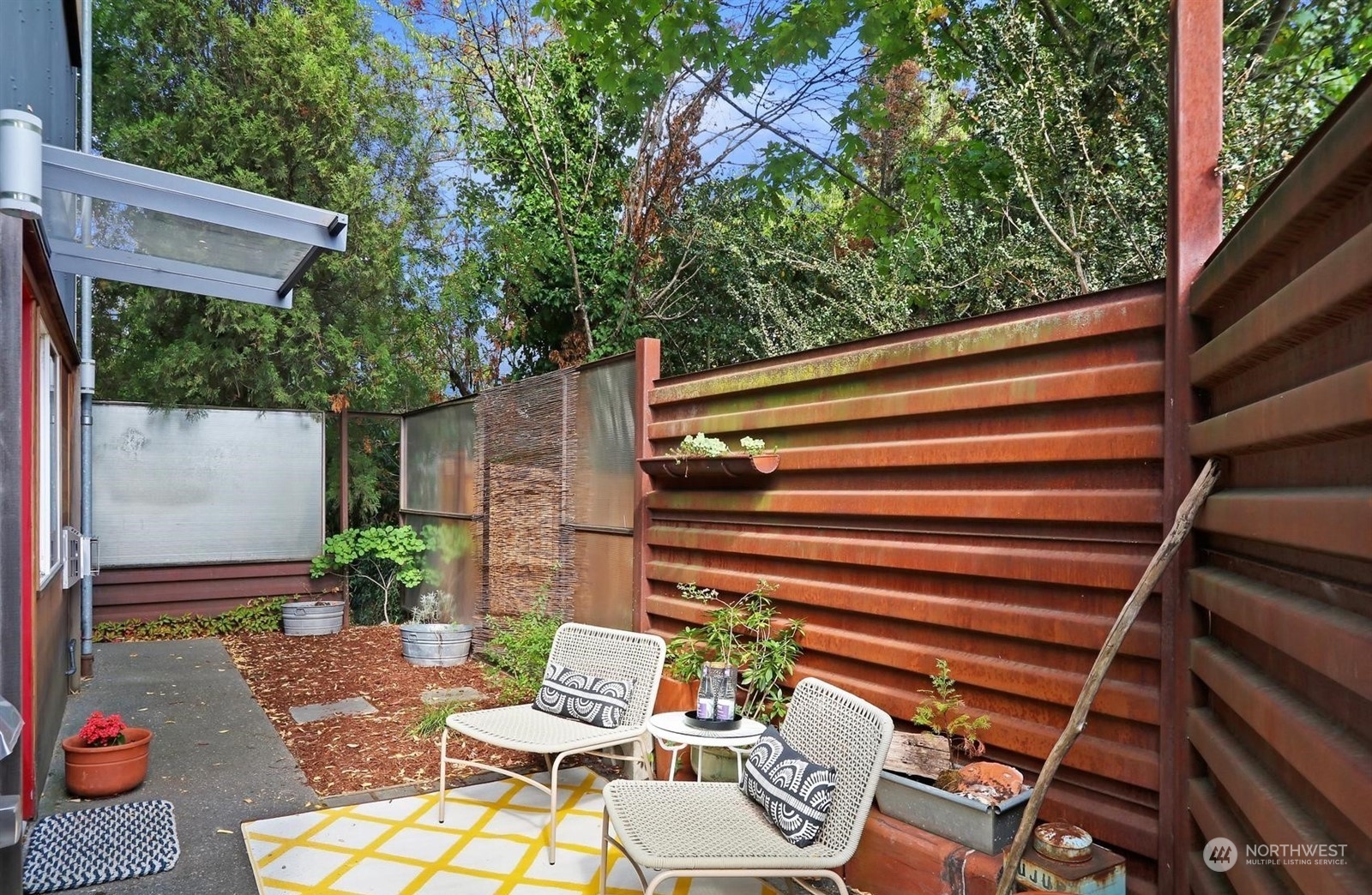 4606 Whitman Avenue North Seattle, WA 98103 - Photo 28 of 40 a view of backyard with outdoor seating and plants