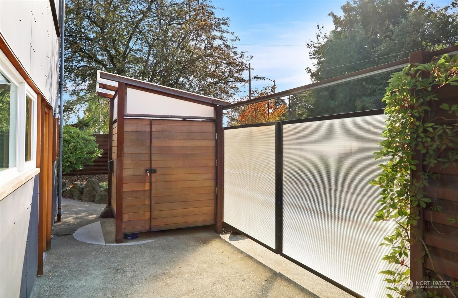 4606 Whitman Avenue North Seattle, WA 98103 - Photo 37 of 40 a view of a glass door with a tree in the background