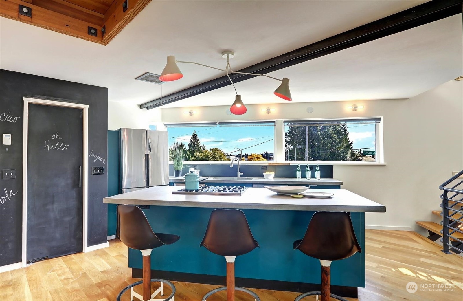 4606 Whitman Avenue North Seattle, WA 98103 - Photo 10 of 40 a room with stainless steel appliances kitchen island granite countertop a table and chairs in it
