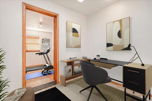 a view of empty room with wooden floor