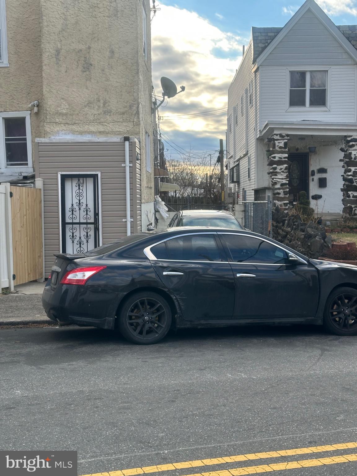 1018 North 66th Street Philadelphia, PA 19151 - Photo 6 of 6 a car parked in front of a brick house
