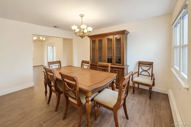 a view of a dining room with furniture and wooden floor