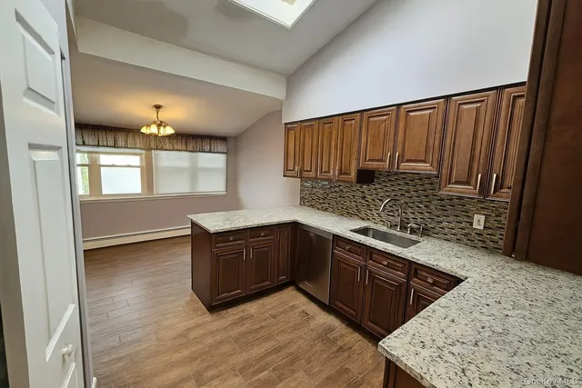 a kitchen with stainless steel appliances granite countertop a sink stove and cabinets