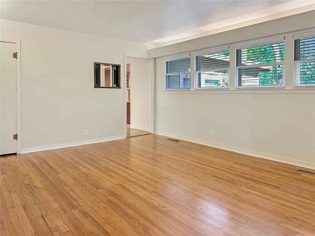 6713 Norma Street Fort Worth, TX 76112 - Photo 12 of 21 a view of empty room with wooden floor and fan