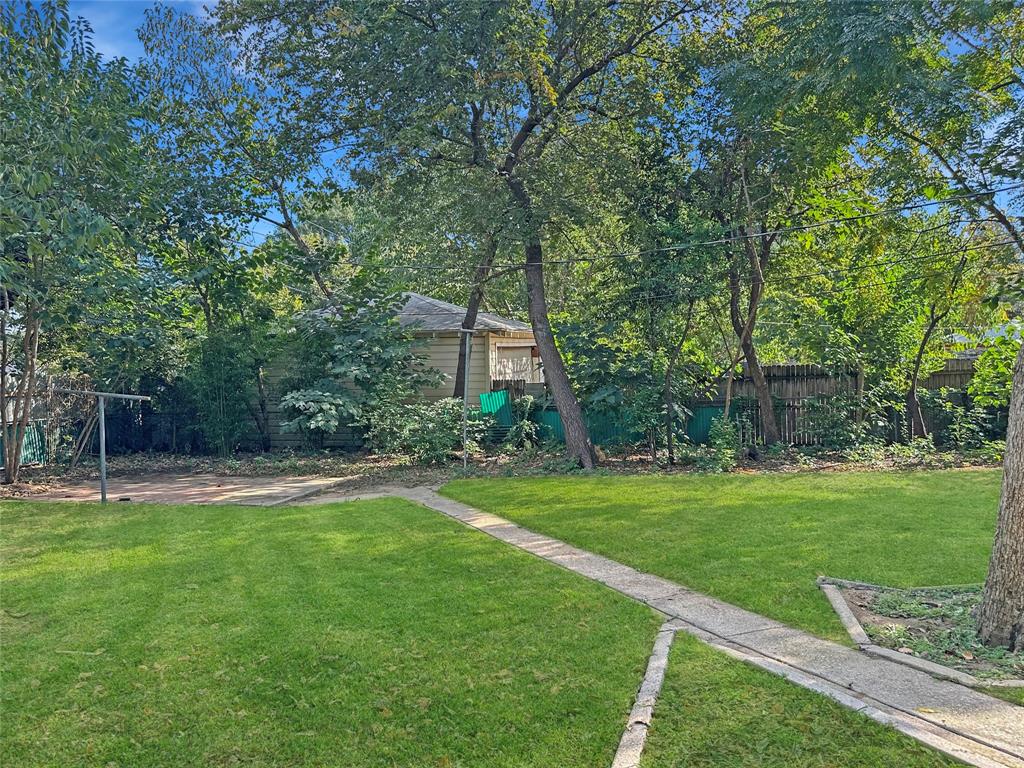 6713 Norma Street Fort Worth, TX 76112 - Photo 15 of 21 a view of a backyard with large trees