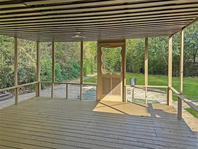 a view of a room with wooden floor and windows