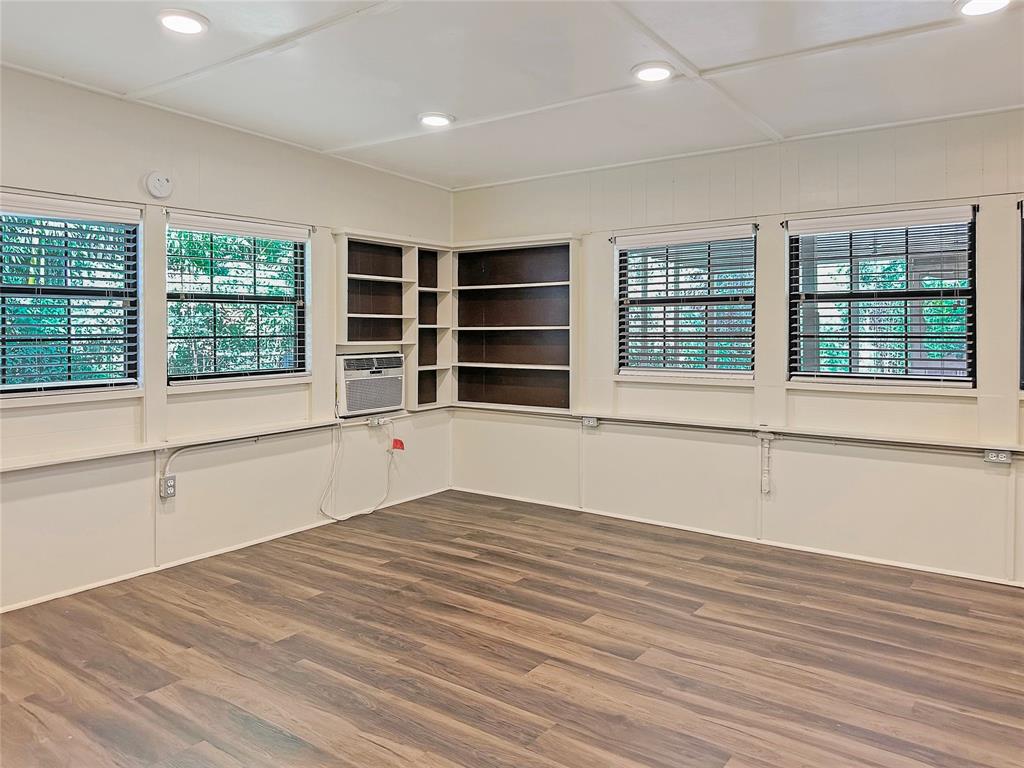 6713 Norma Street Fort Worth, TX 76112 - Photo 18 of 21 a view of an empty room with a window and wooden floor
