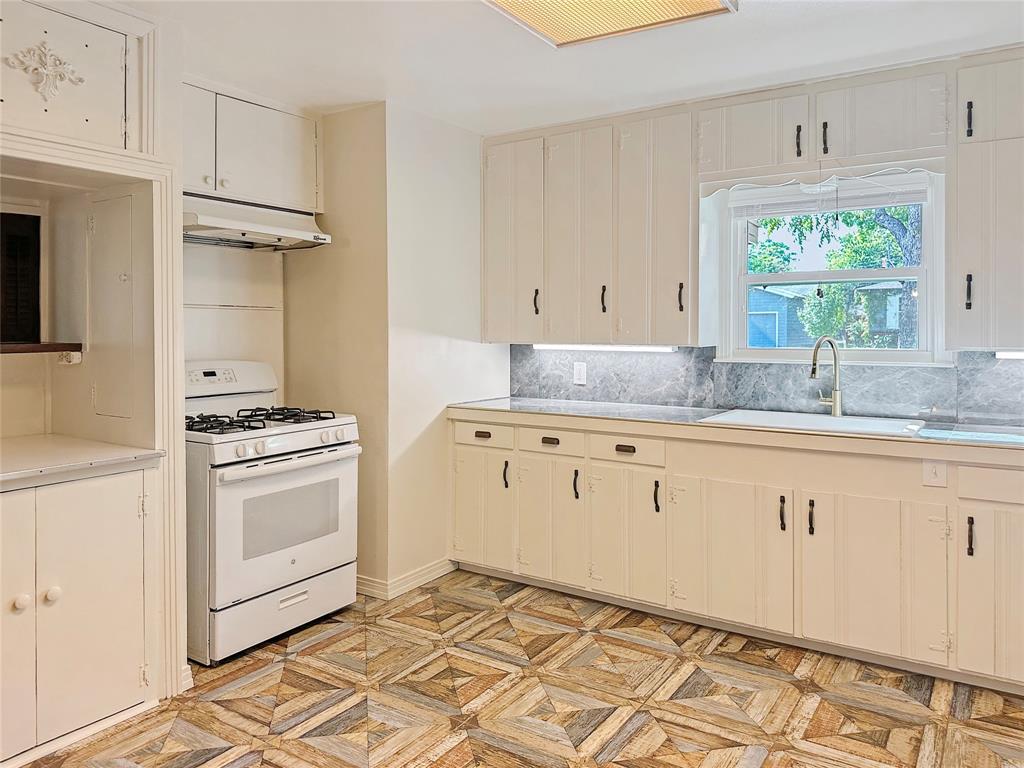 6713 Norma Street Fort Worth, TX 76112 - Photo 4 of 21 a kitchen with granite countertop white cabinets and white appliances