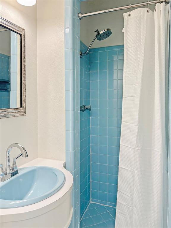 6713 Norma Street Fort Worth, TX 76112 - Photo 7 of 21 a bathroom with a sink and shower
