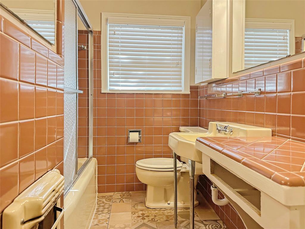 6713 Norma Street Fort Worth, TX 76112 - Photo 10 of 21 a bathroom with a sink a toilet and a mirror
