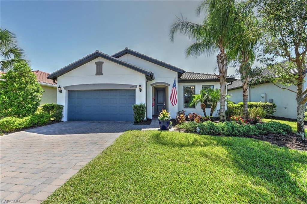 2106 Clementine Street Naples, FL 34120 - Photo 1 of 34 a front view of a house with a yard and porch