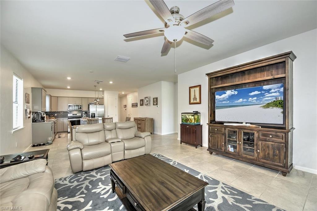 2106 Clementine Street Naples, FL 34120 - Photo 12 of 34 a living room with furniture and a flat screen tv
