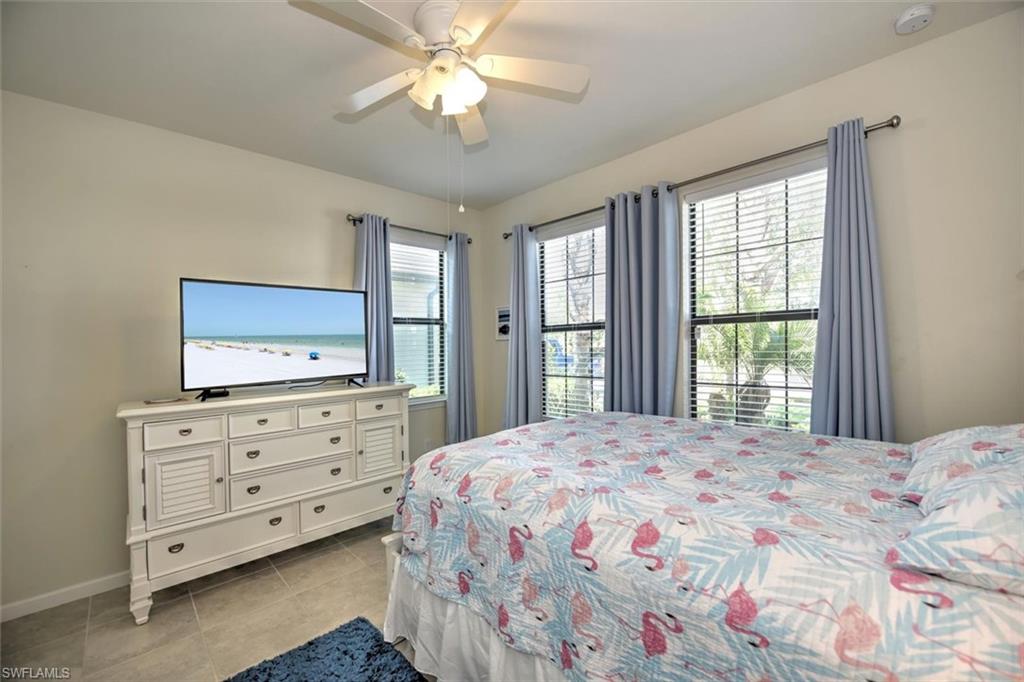 2106 Clementine Street Naples, FL 34120 - Photo 17 of 34 a bedroom with a bed and a dresser