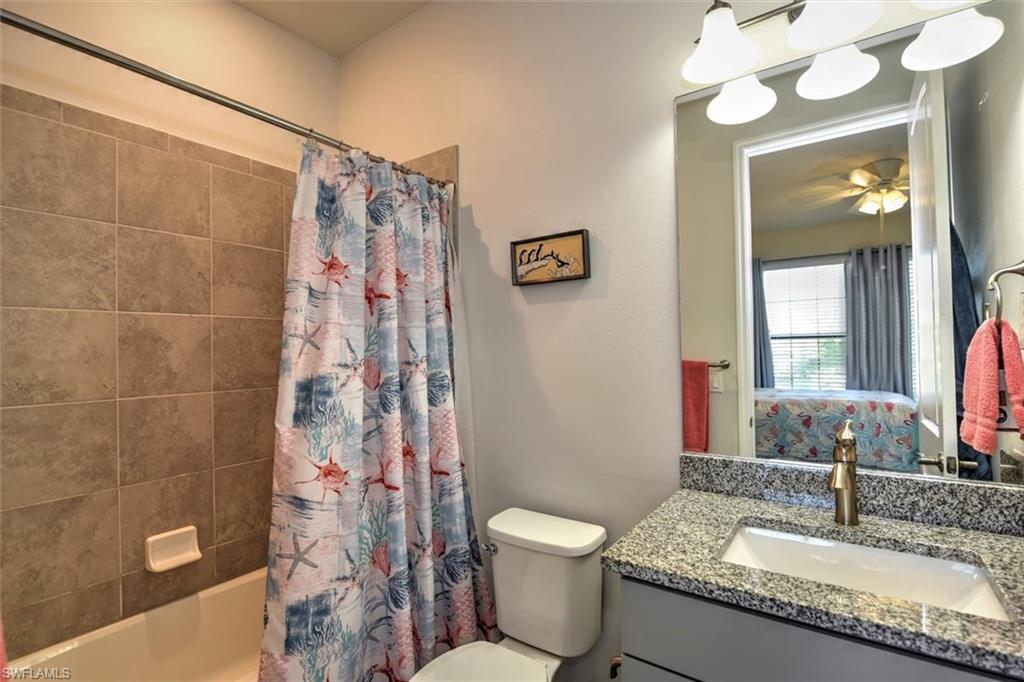 2106 Clementine Street Naples, FL 34120 - Photo 19 of 34 a bathroom with a granite countertop sink a toilet and a mirror