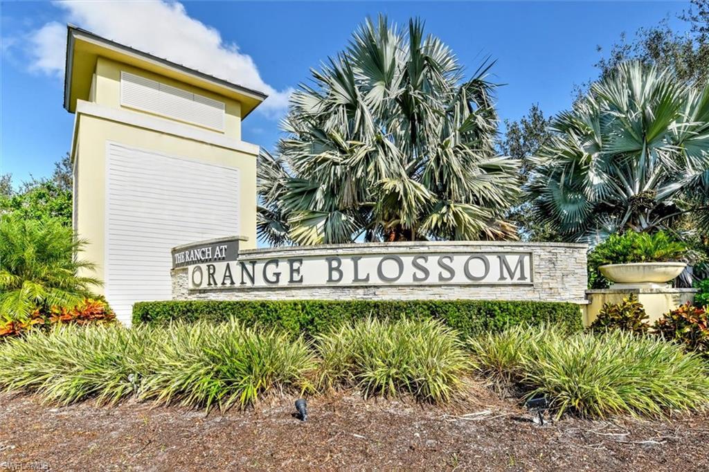 2106 Clementine Street Naples, FL 34120 - Photo 2 of 34 a sign broad in front of flowers