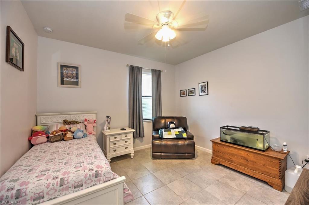 2106 Clementine Street Naples, FL 34120 - Photo 23 of 34 a bedroom with a bed and a couch