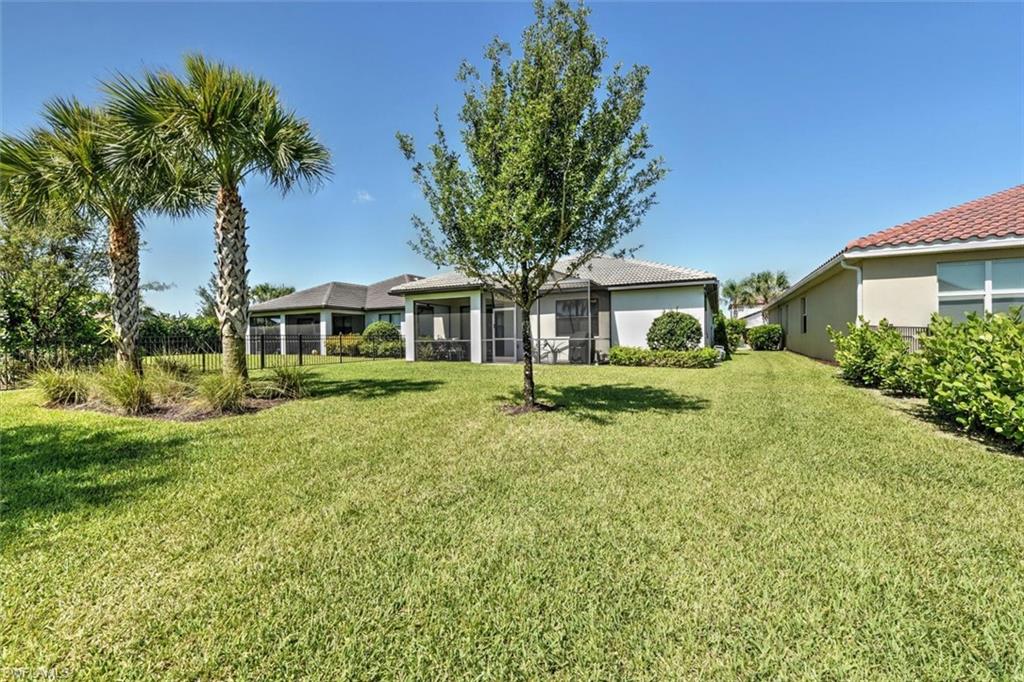 2106 Clementine Street Naples, FL 34120 - Photo 28 of 34 front view of a house with a yard
