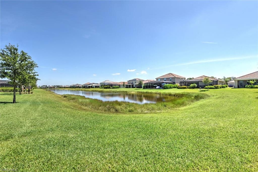2106 Clementine Street Naples, FL 34120 - Photo 29 of 34 a view of a lake with houses in the back