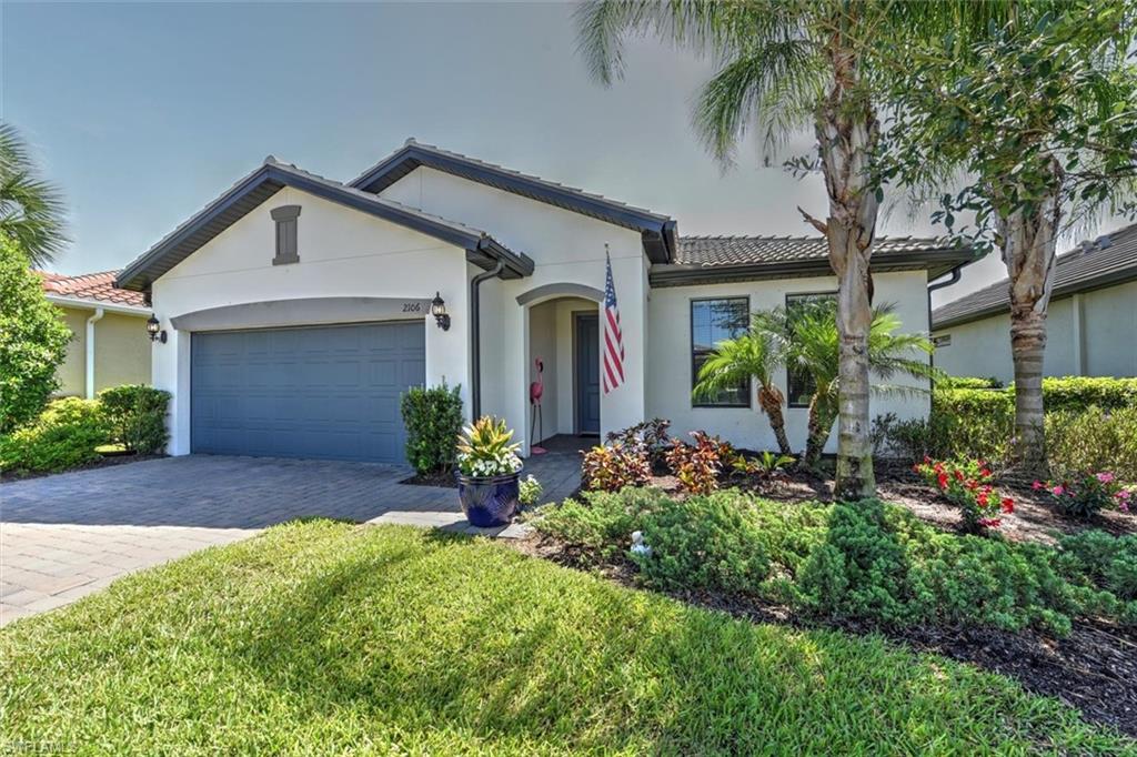 2106 Clementine Street Naples, FL 34120 - Photo 3 of 34 a front view of house with yard and green space