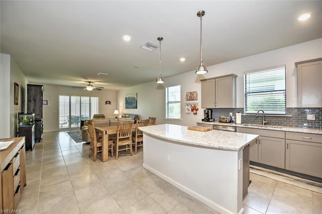 2106 Clementine Street Naples, FL 34120 - Photo 4 of 34 a large kitchen with a table and chairs